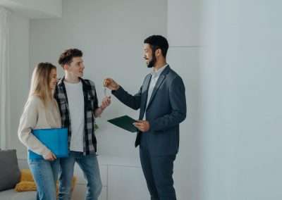 agent giving keys to young couple